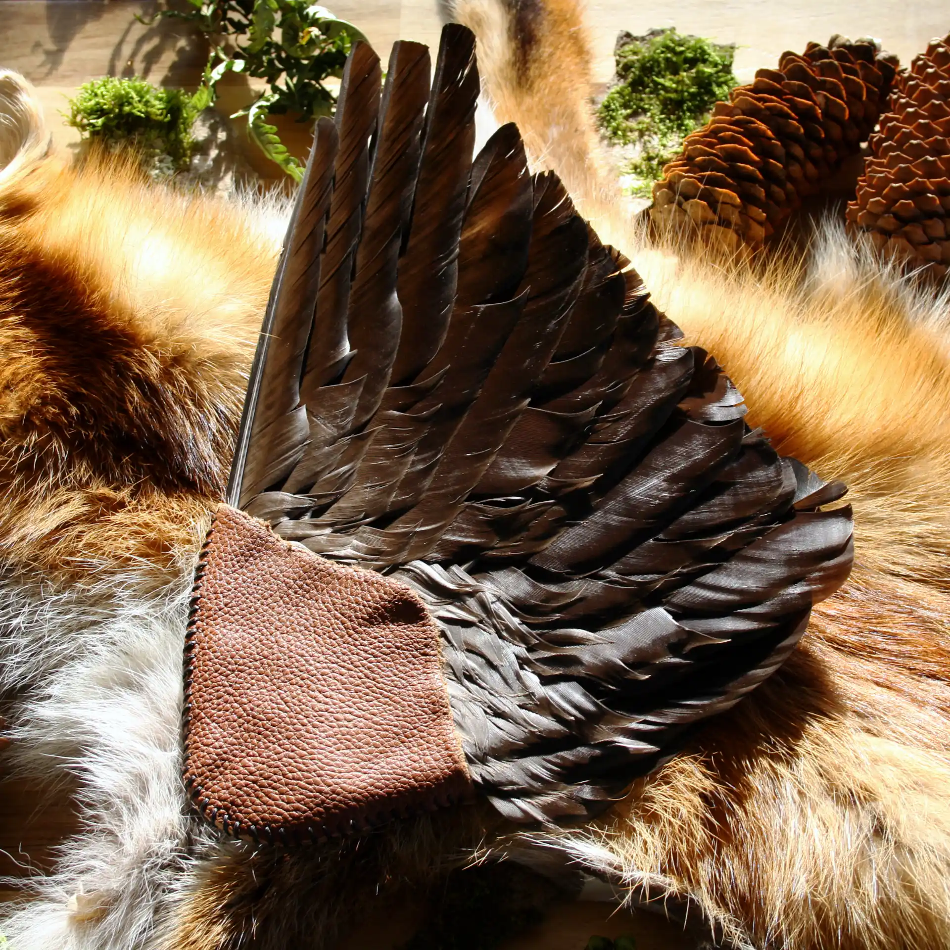 Rückseite des Räucherfächers aus dunklen Rabenfedern mit braunem Ledergriff